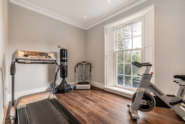 one white uPVC Georgian sliding sash window in a home gym
