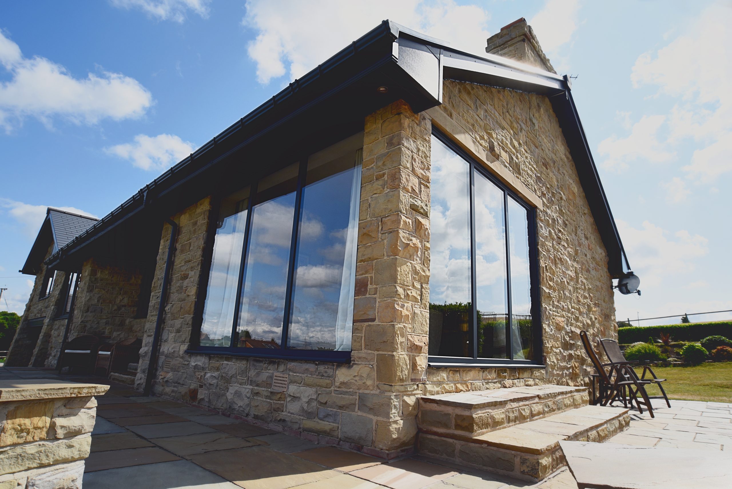 Aluminium bi-fold doors and windows in Wendy's kitchen diner, Brighouse, bring modern style and natural light.
