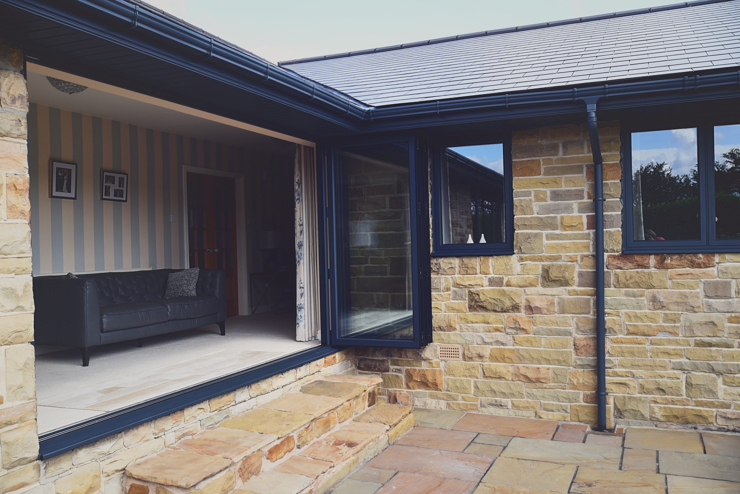 Quickslide helps Wendy with a custom triangular window in her kitchen diner, using aluminium frames for more light.
