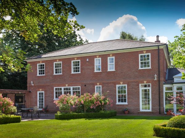 Timber-style uPVC sliding sash windows with a slim midrail
