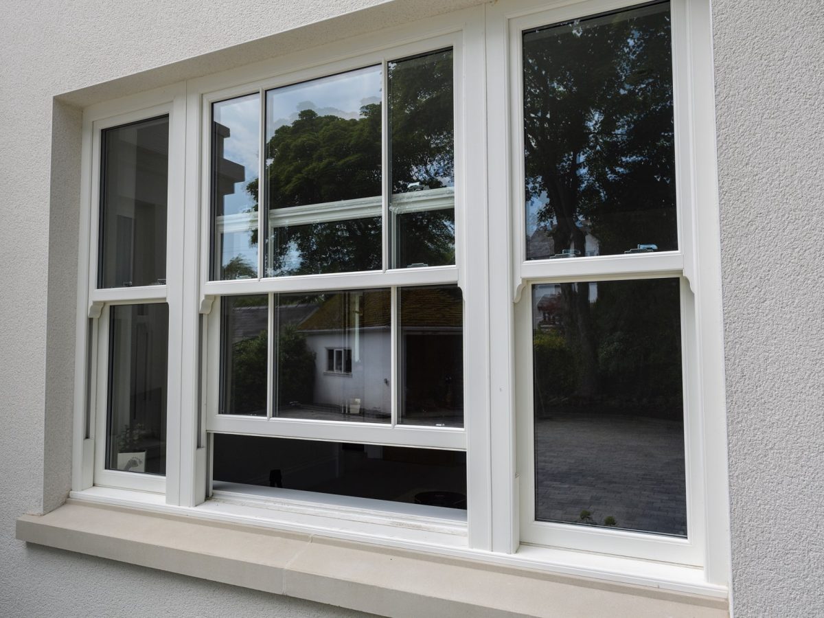 Elegant white grain sliding sash windows, combining style and modern functionality.