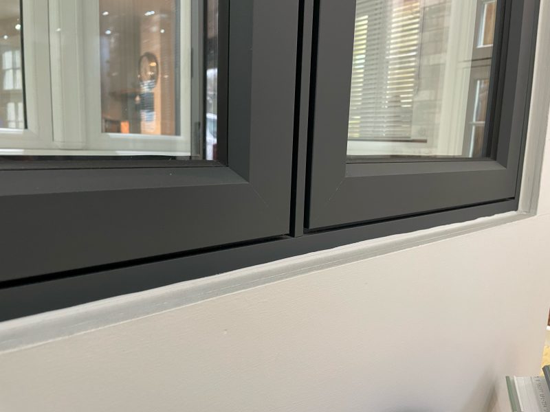 Close-up of the chamfered smooth profile on an aluminium casement window frame