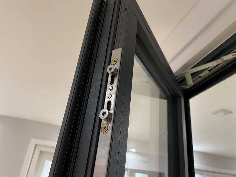 Close-up of the multi-point locking mechanism in an aluminium window, ensuring enhanced security