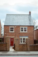 Red brick home featuring new cream uPVC sash windows for a stylish finish