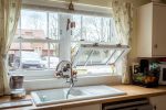 White uPVC sash windows providing natural light in a modern kitchen setting