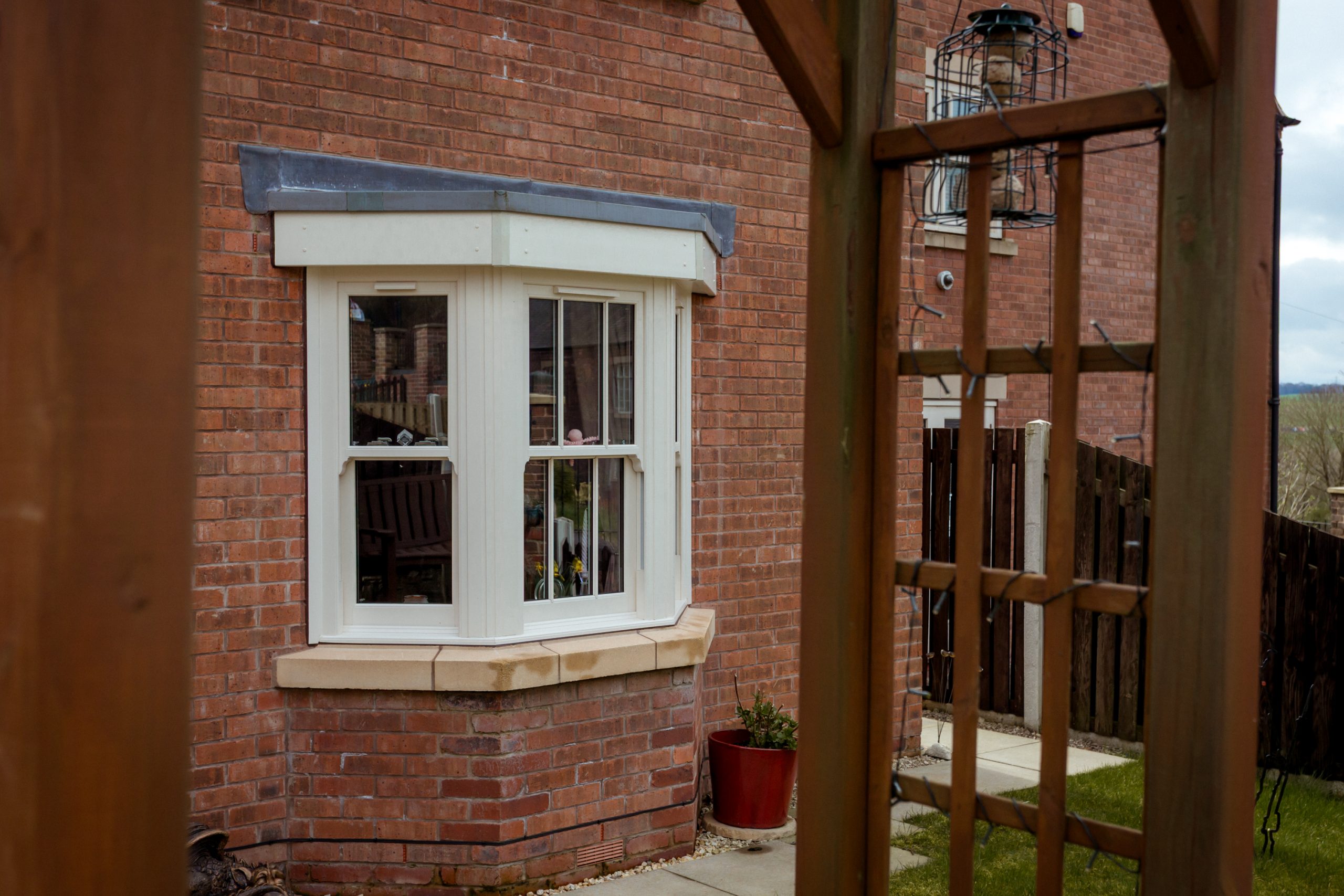uPVC sash windows with astragal bars designed to replicate traditional timber windows in a conservation setting