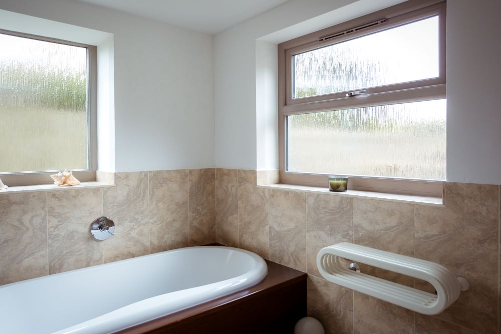 Glass with bark-like texture blurs the background, creating a decorative yet private glazing effect
