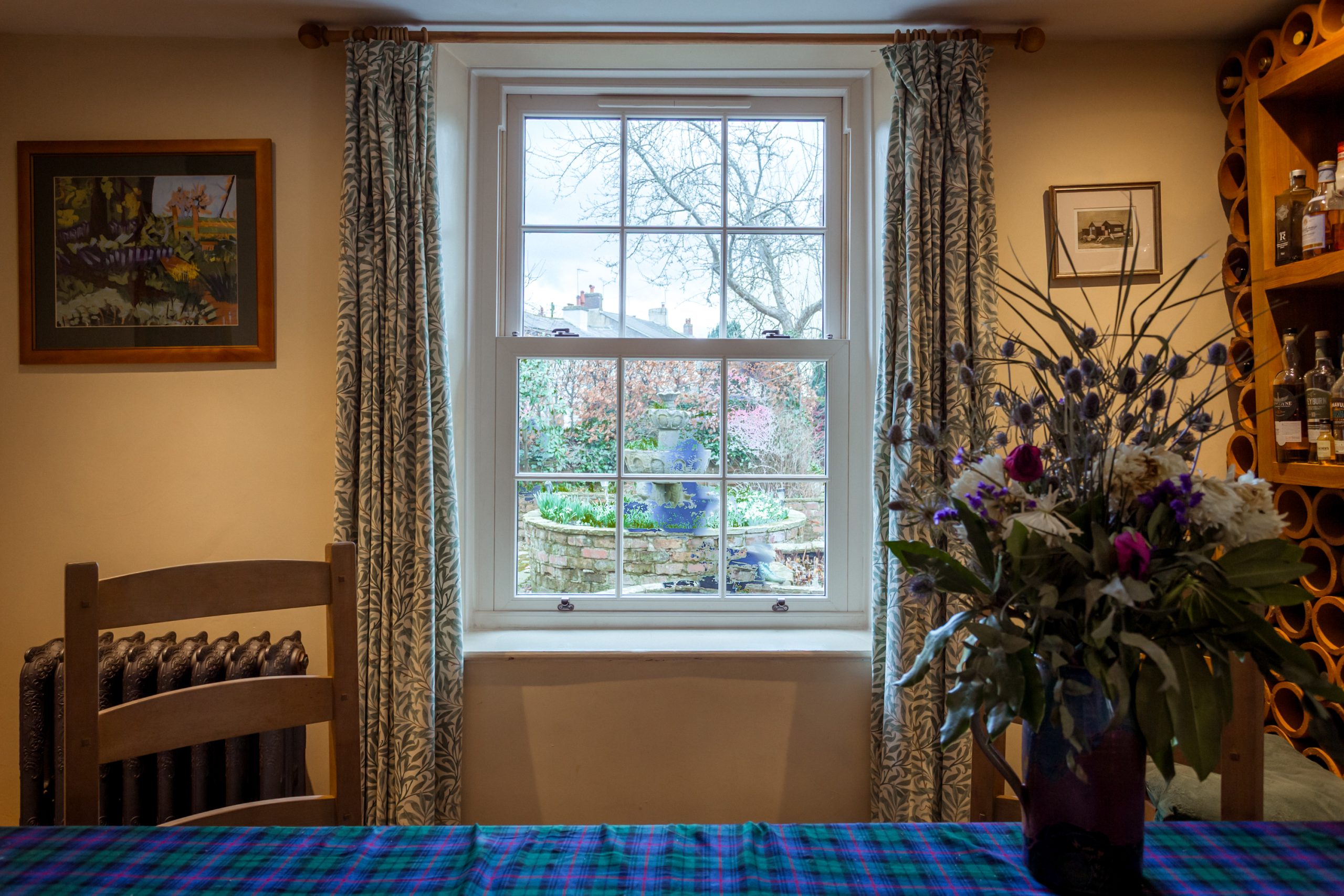 Close-up of Quickslide uPVC sliding sash window in cream woodgrain finish.