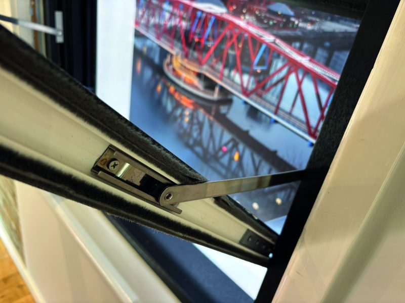 Close-up of reinforced metal tilt arms designed for durable and reliable sash window movement