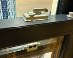 Close-up of 2x high security locks and keeps fitted to a sash window for enhanced safety