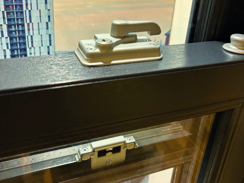 Close-up of 2x high security locks and keeps fitted to a sash window for enhanced safety