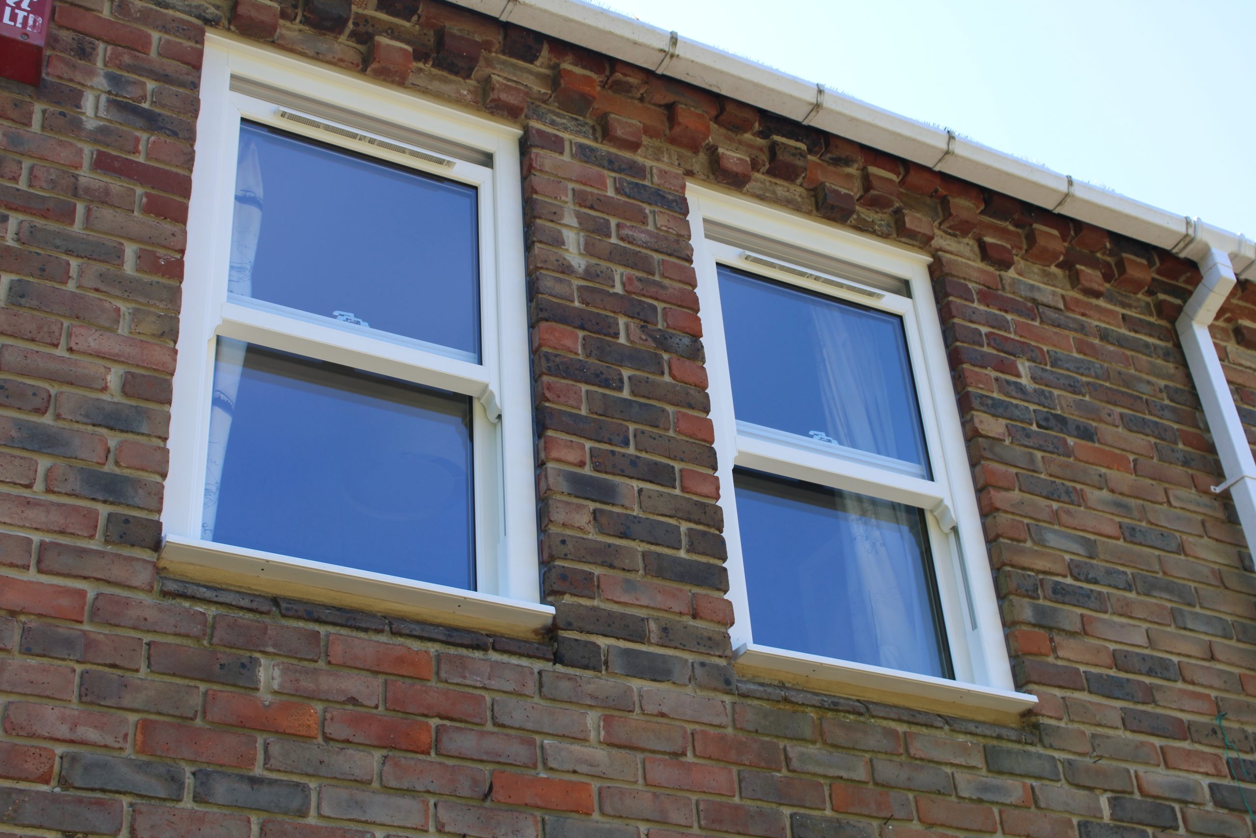 Front elevation of home featuring new white uPVC sliding sash windows