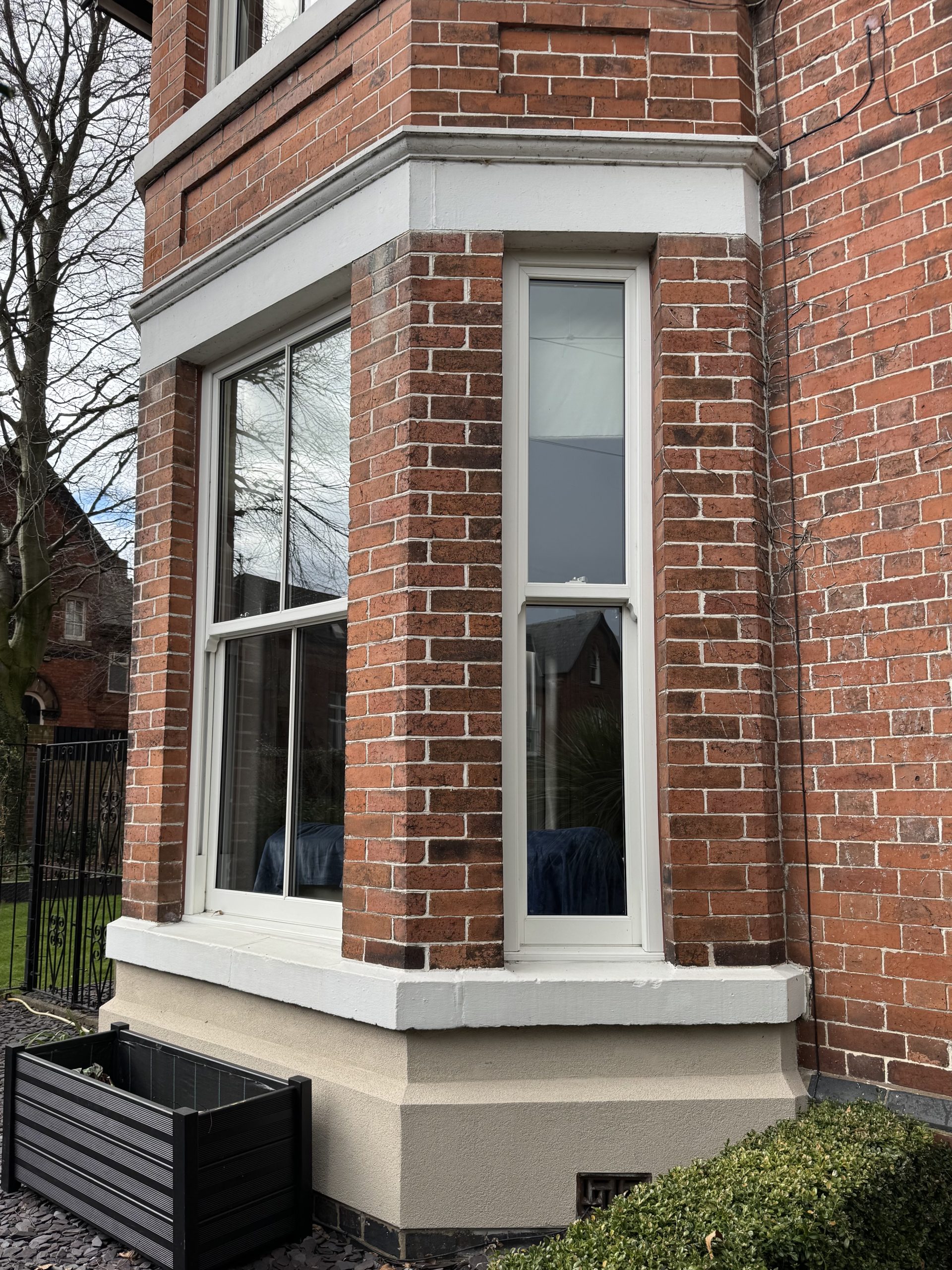 White woodgrain uPVC sliding sash windows replacing old timber windows