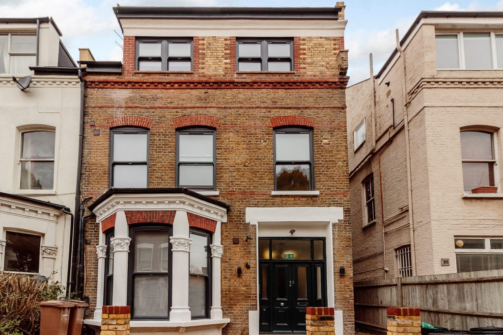 Black woodgrain VS. Curious and unique black wood effect sash upvc windows.
