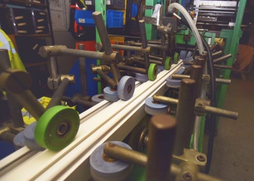 pic42-new The woodgrain foil is bonded to the PVC profile using hot glue and rollers at our Brighouse facility, ensuring durability and quality.