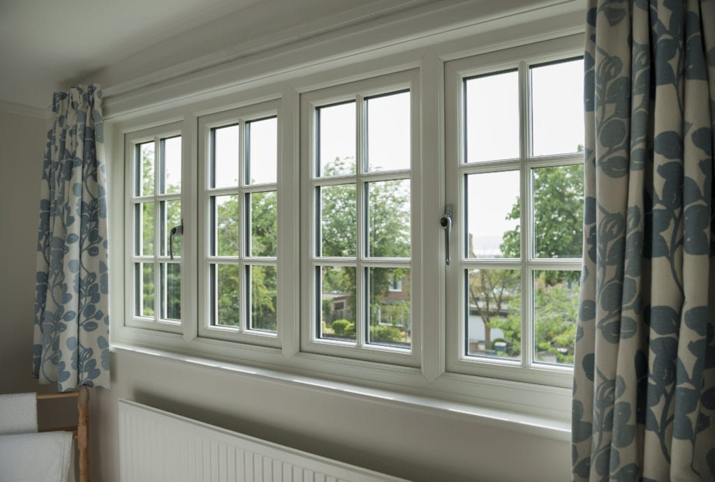 uPVC white casement windows with astragal bars and curtains