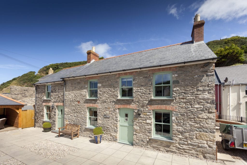 green upvc sliding sash windows on a heritage property