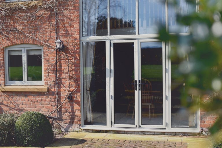 Aluminium French Doors with Sidelights in Agate Grey: When to Replace Patio Doors. Amidst a surge in demand for home renovations, homeowners are seizing the opportunity to upgrade their living spaces, leading to increased interest in patio door replacements.