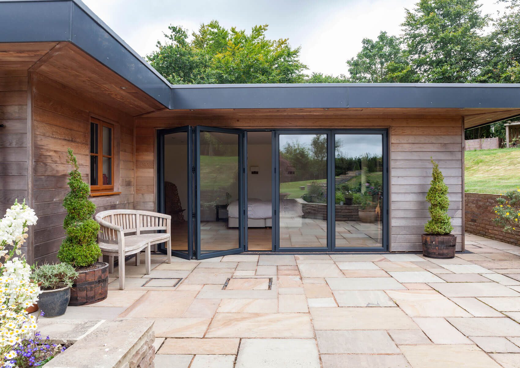 Exterior sliding glass doors, presenting options between bifold doors or sliding doors. Explore versatile solutions for enhancing outdoor spaces with these stylish and functional door options.