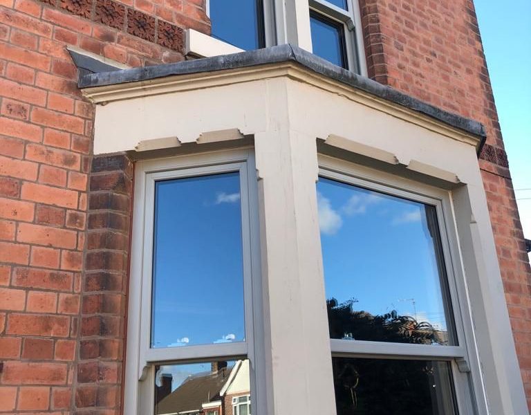 Light grey sliding sash bay windows