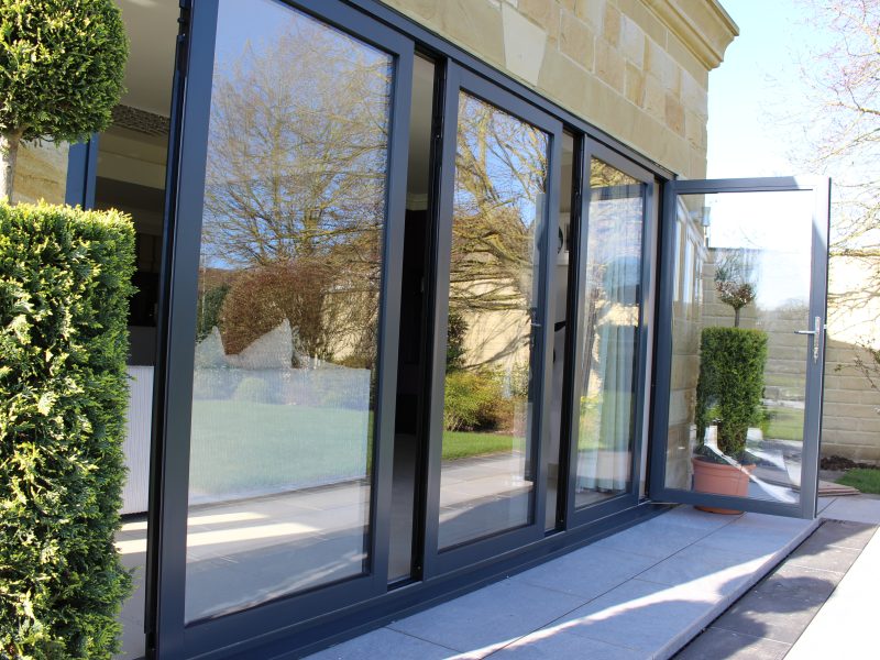 Indifold doors, demonstrating their sliding and folding mechanism, providing adaptable space usage and modern aesthetics