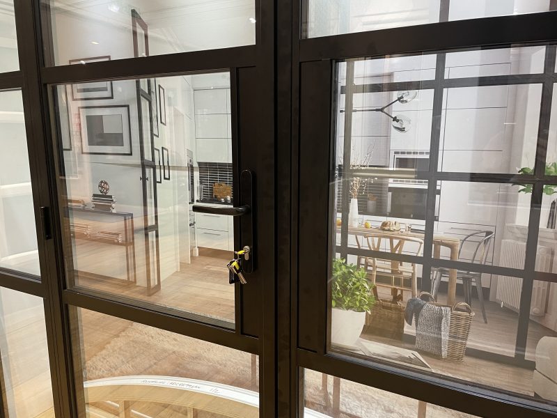 Aluminium heritage door handle placed neatly between slim horizontal glazing bars