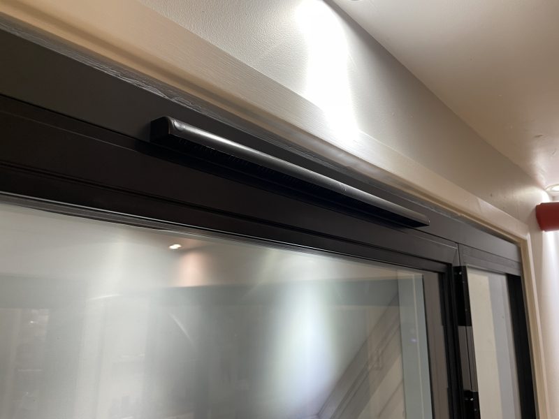 Subtle trickle vent integrated into aluminium door frame for improved airflow