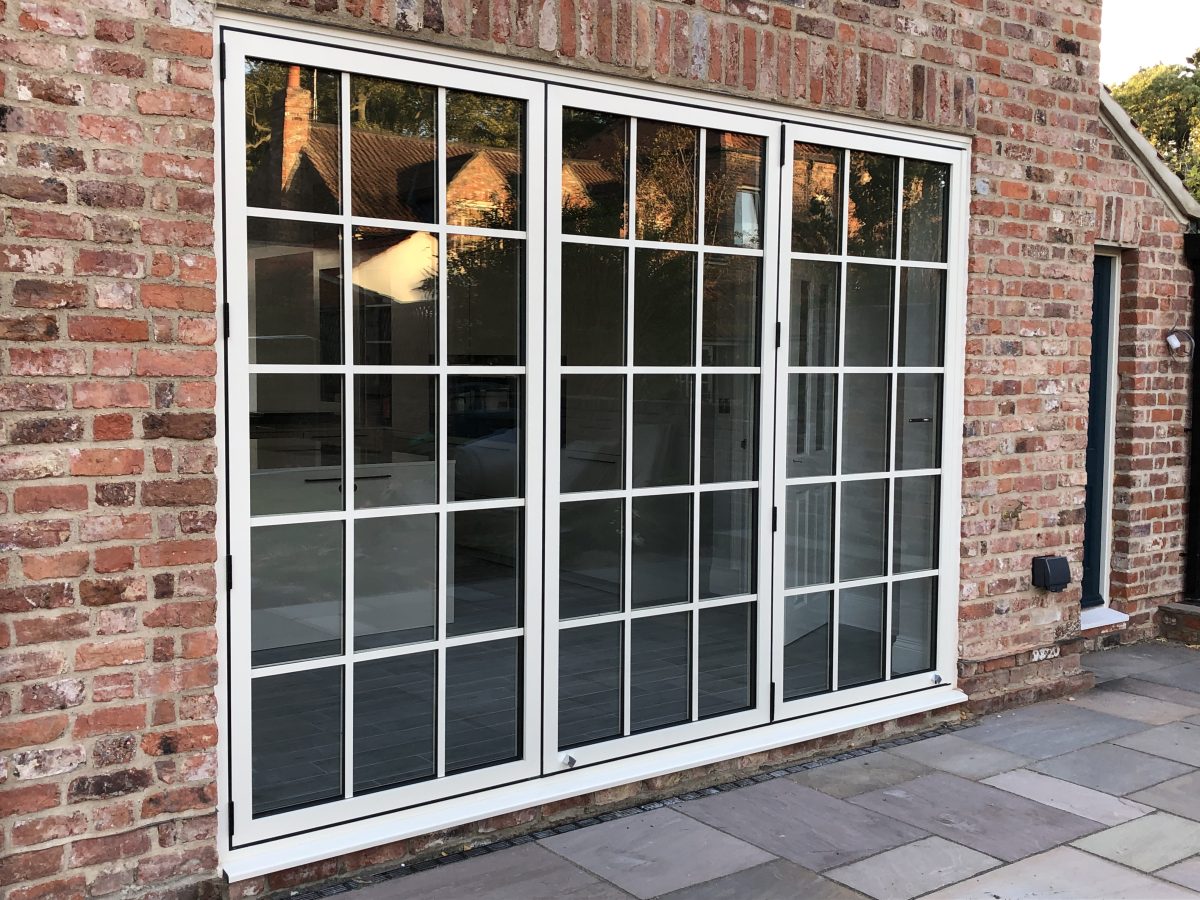 Contemporary aluminium bifold doors folded open, blending indoor and outdoor living