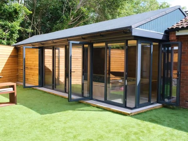 A modern interior with slide and fold doors seamlessly integrating indoor and outdoor spaces