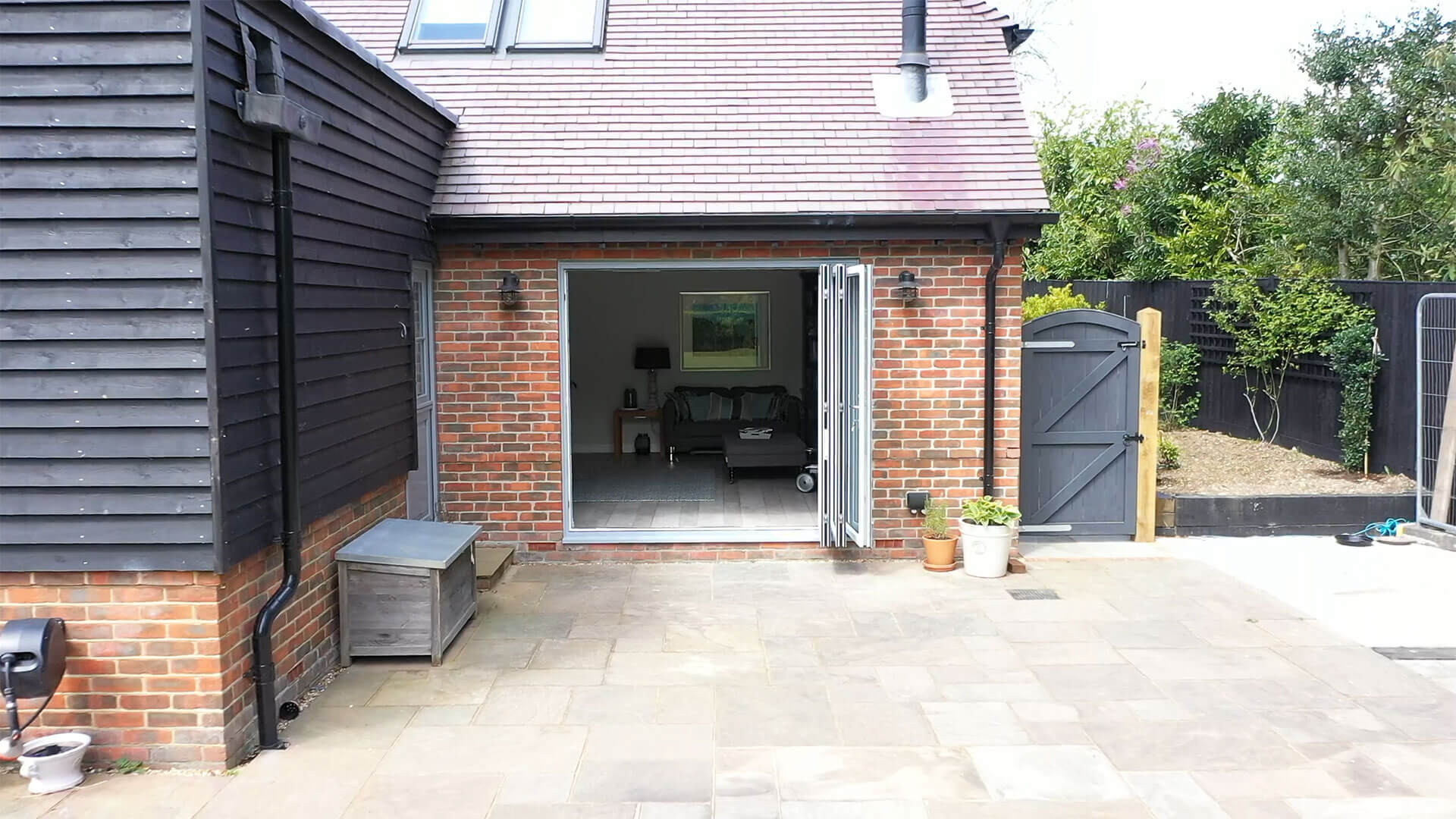 An inviting patio adorned with slide and fold doors, creating a seamless transition between indoor and outdoor spaces