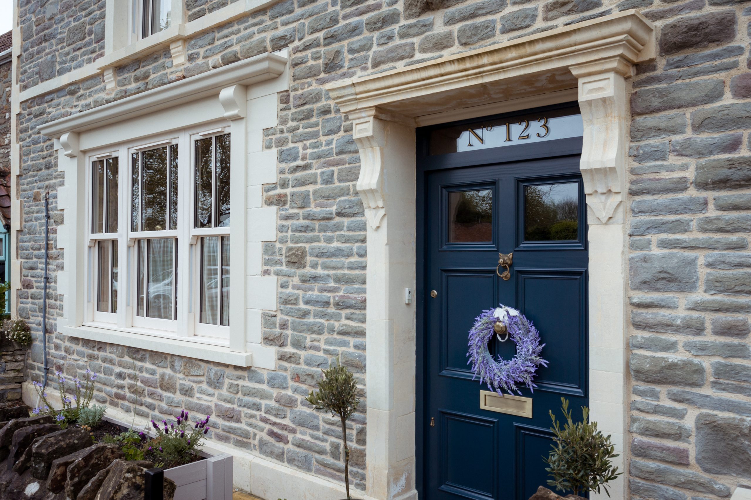 Exterior view of Georgian house featuring newly installed uPVC sliding sash windows.