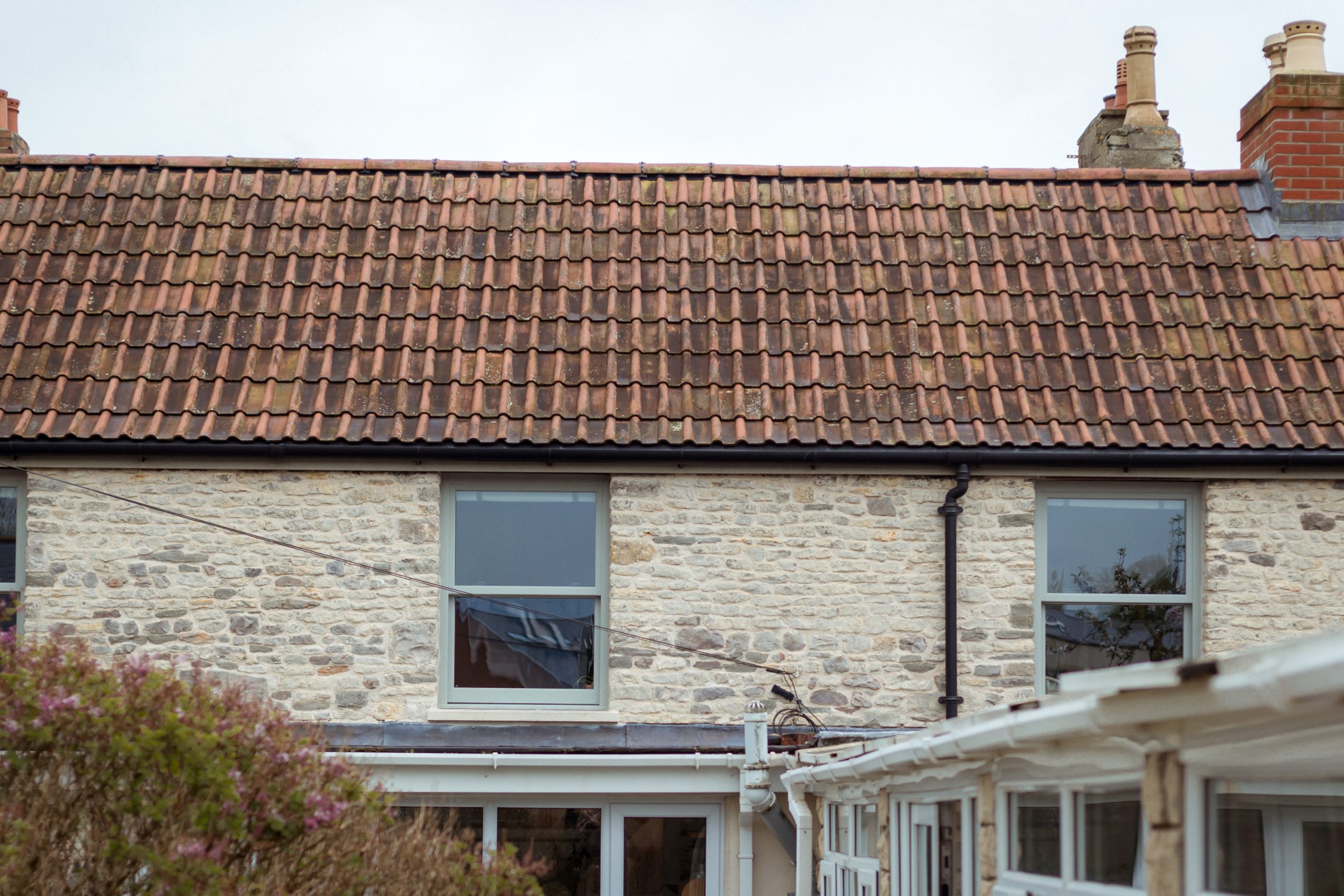 Rear view showing three agate grey woodgrain finish Legacy sliding sash windows.