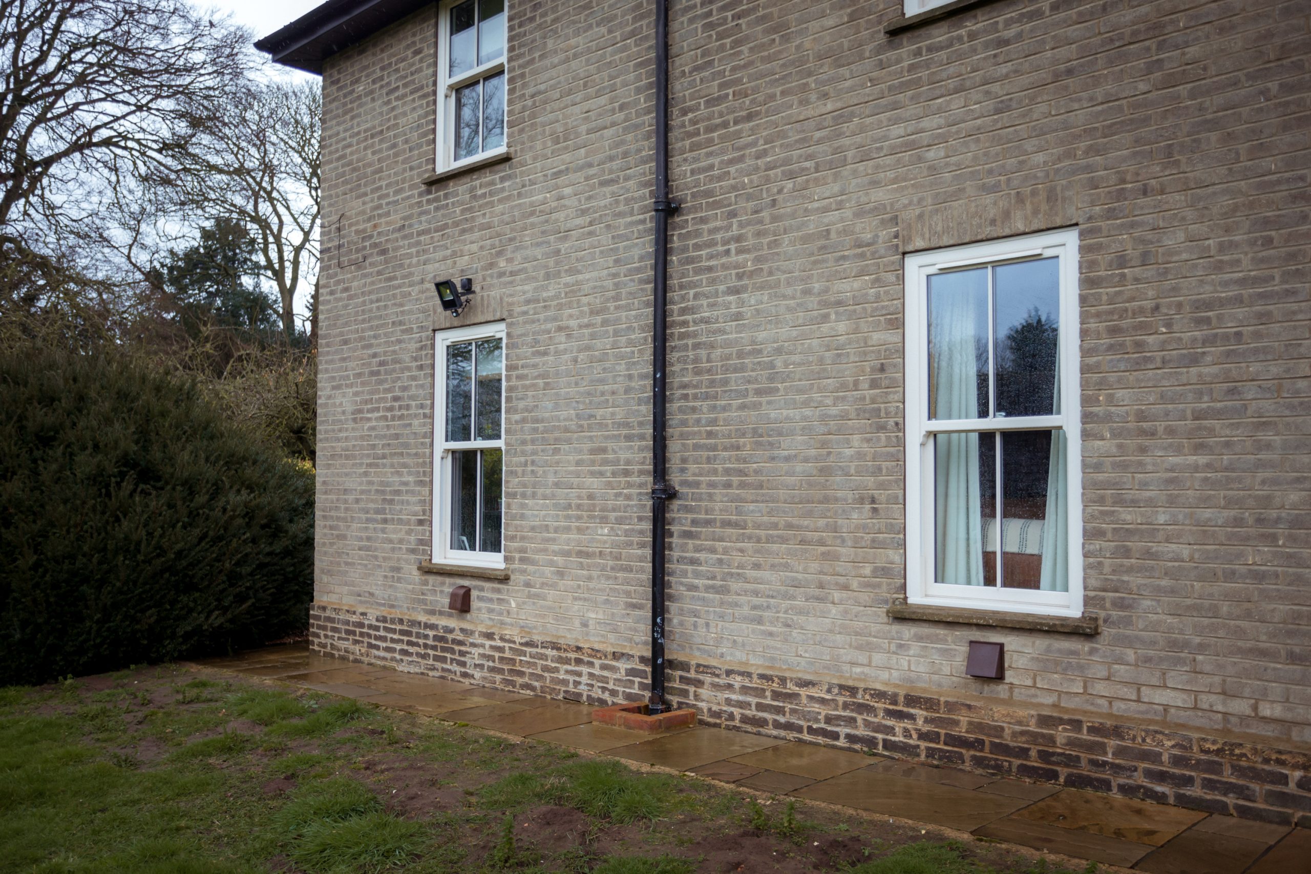 Cream woodgrain sliding sash windows supplied by Quickslide for a full house project.