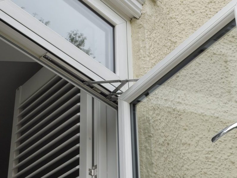 Close-up of a friction stay on a uPVC window, allowing smooth operation and adjustable opening angles