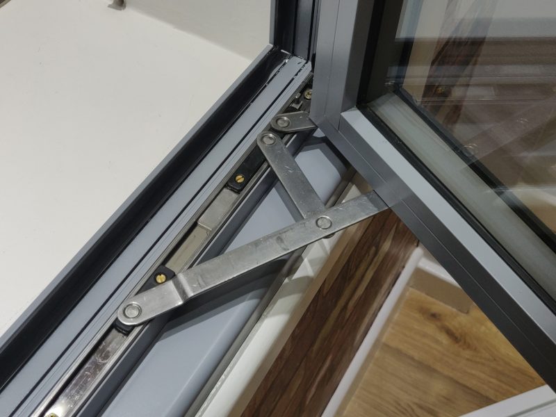 Close-up of the friction stay mechanism, enabling smooth and secure operation of an aluminium casement window