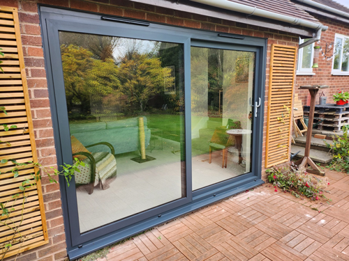 Aluminium sliding patio doors featuring loose sashes and glass, designed for easy installation and transport