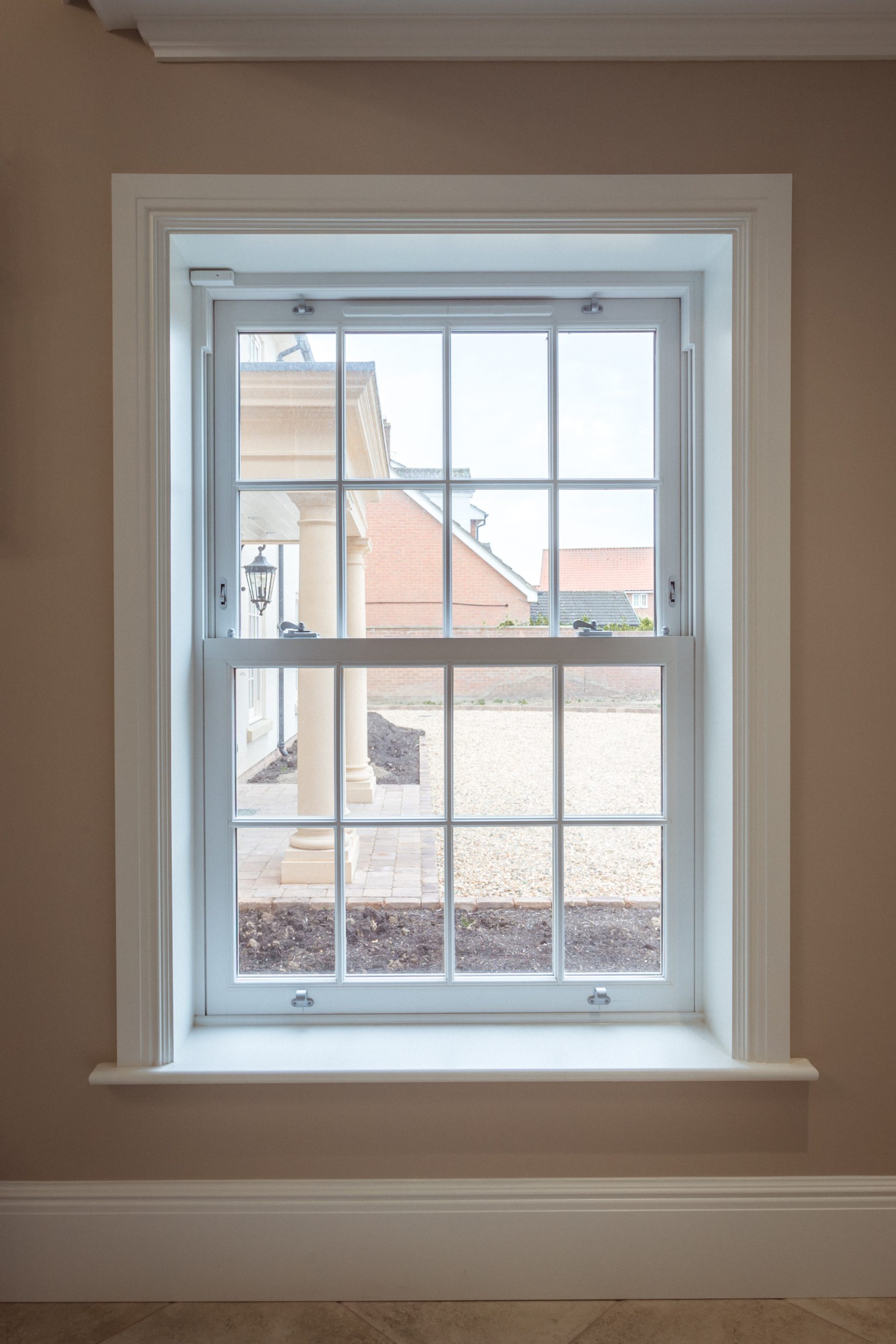 Heritage-style sash windows with run-through horns and astragal bars.
