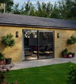 Slim-framed aluminium sliding doors with full-height glass panels for panoramic garden views
