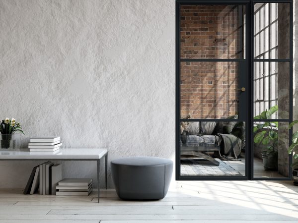Steel-look fixed interior screen with ultra-slim aluminium frame and clear glazing, separating two open-plan rooms.