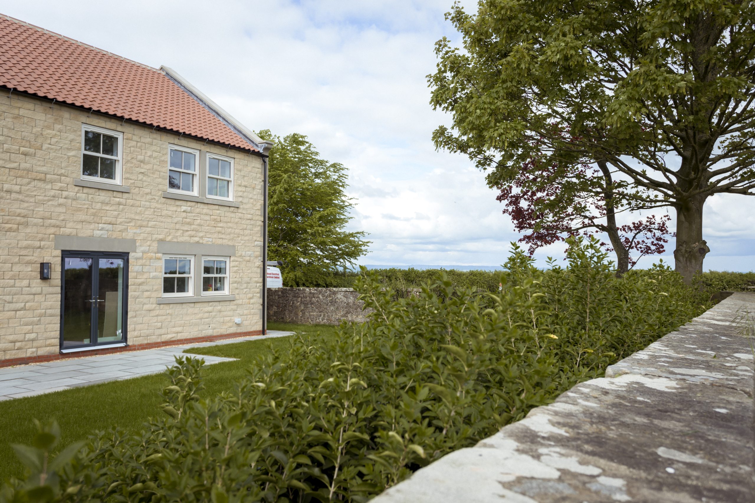 Modern aluminium French doors, ideal for new build developments, paired with matching windows