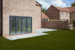 Aluminium bifold doors installed in a new build home, creating a bright and spacious living area