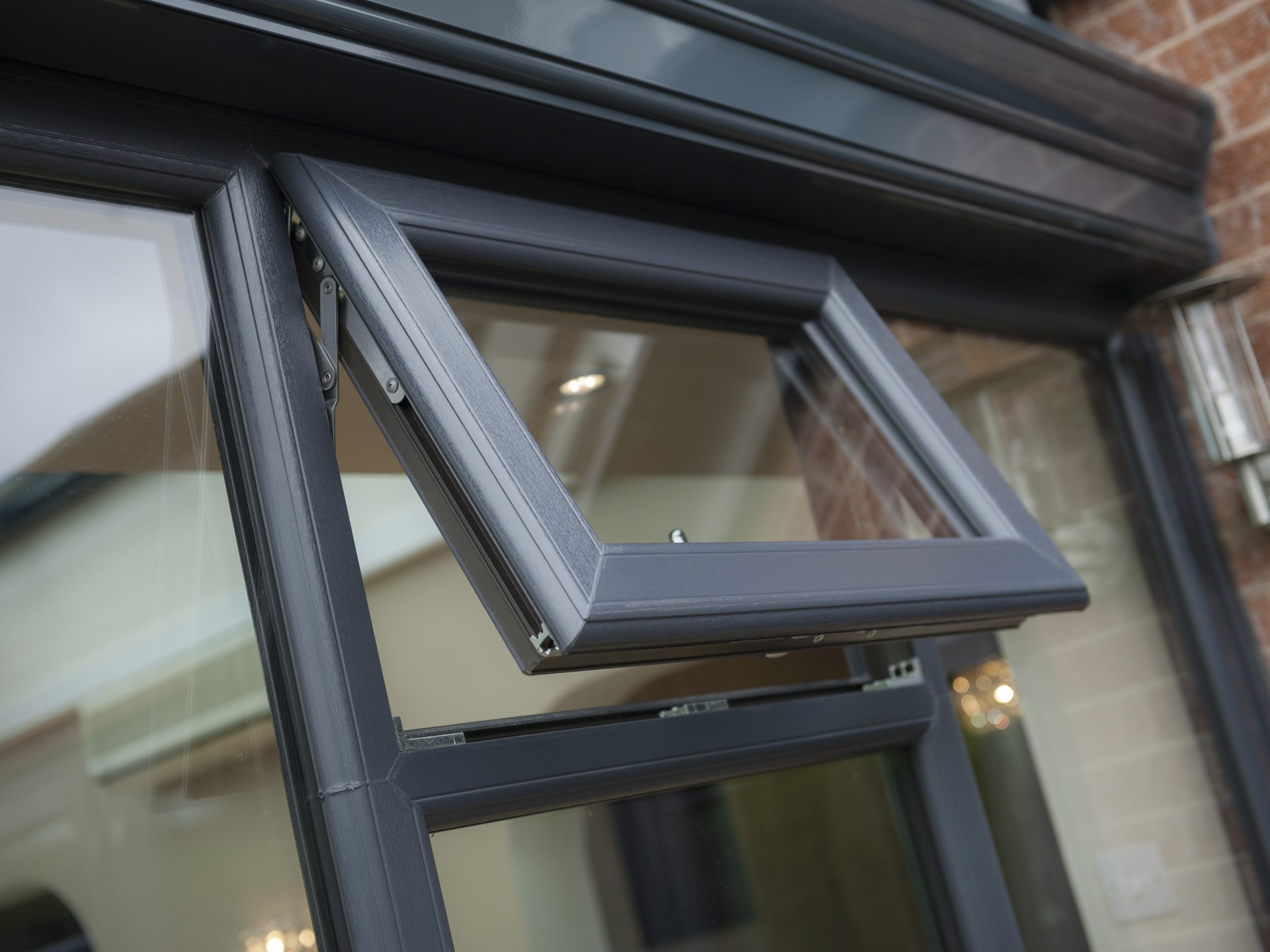 Close-up of a grey top opener uPVC window, showcasing its sleek design and functionality
