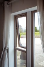 Top-hung uPVC casement window partially open