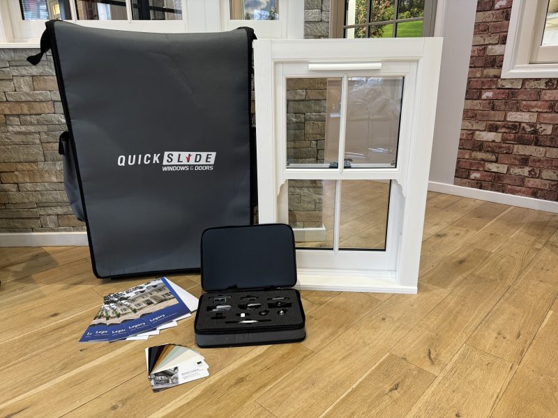 Branded wheeled sample case for sash windows, featuring brochures, swatches, glass samples, and hardware for trade installers