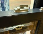 Close-up of 2x high security locks and keeps fitted to a sash window for enhanced safety