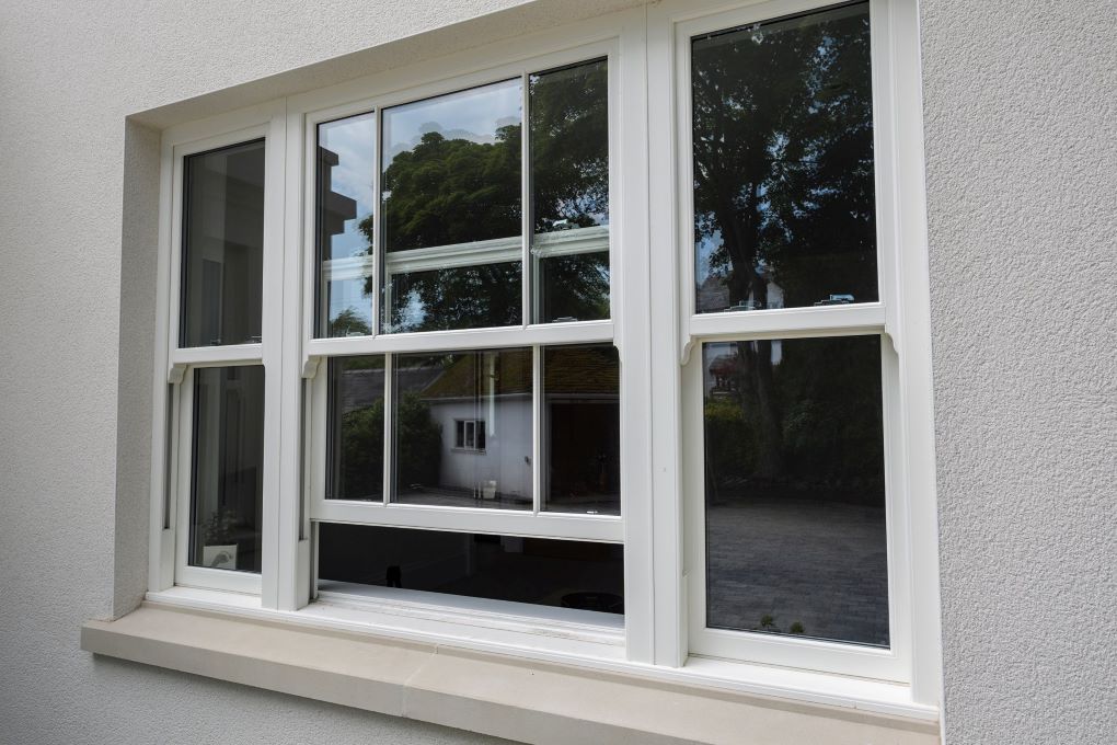 Elegant white grain sliding sash windows, combining style and modern functionality.