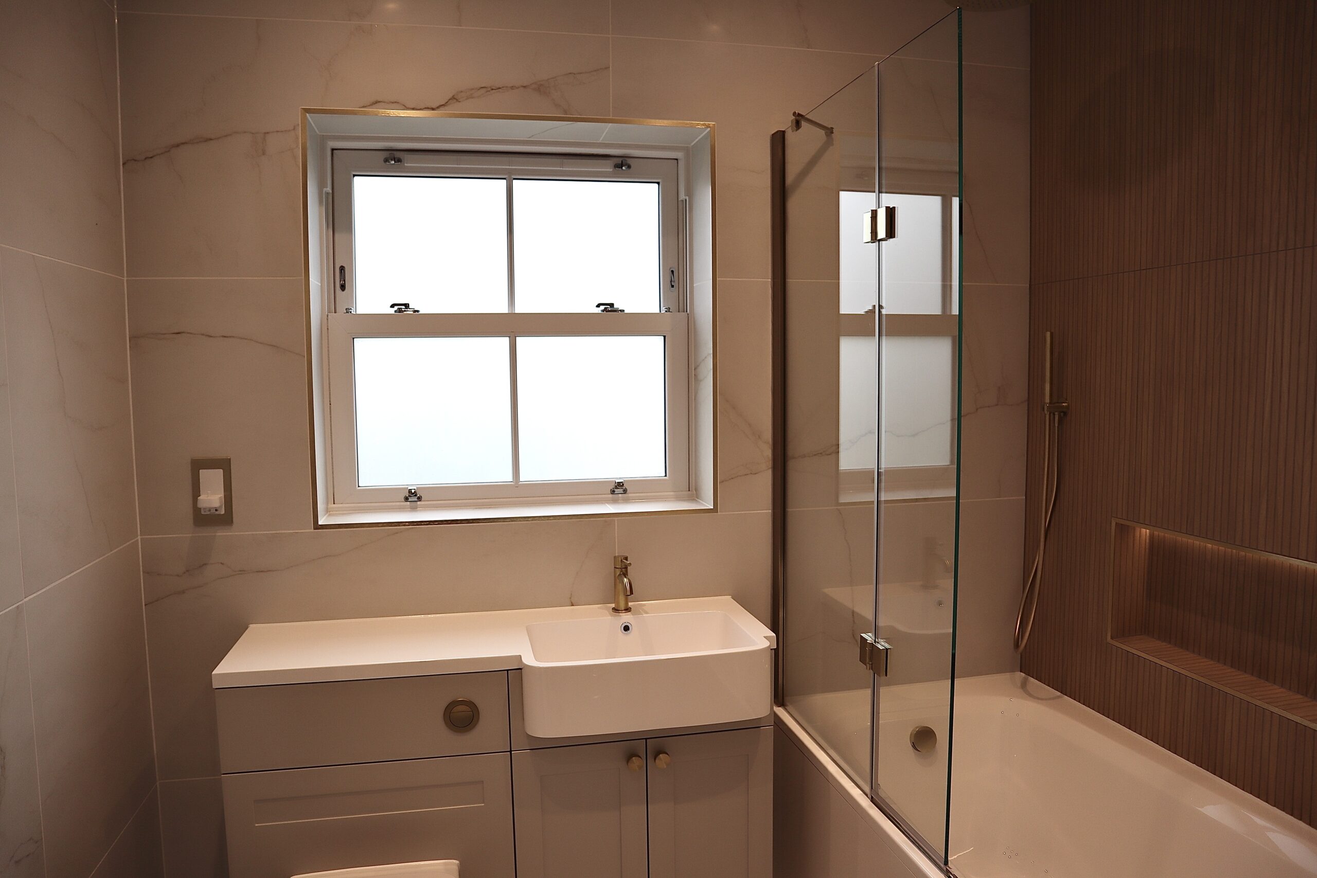 Interior view of a modern bathroom featuring an agate grey sash window providing natural light