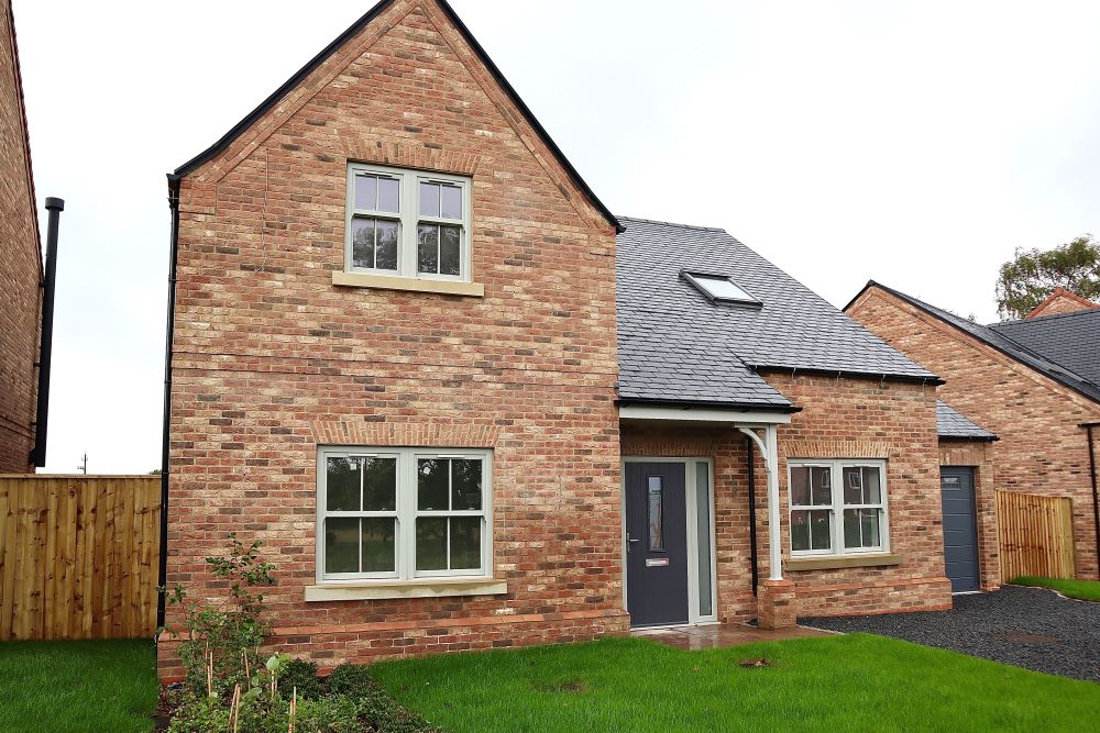 House exterior with uPVC sash windows designed to work with Kubu® smart security sensors.