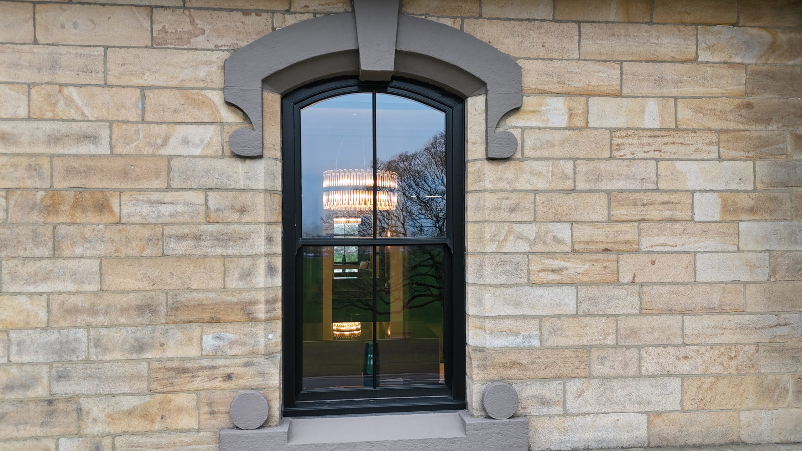 Black woodgrain sash windows complementing traditional architecture