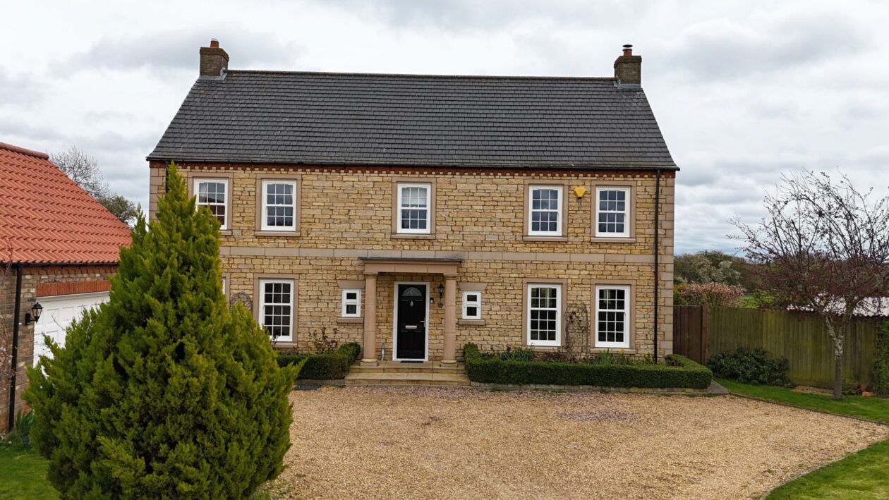 Exterior view showing authentic timber-look uPVC sash windows on period home